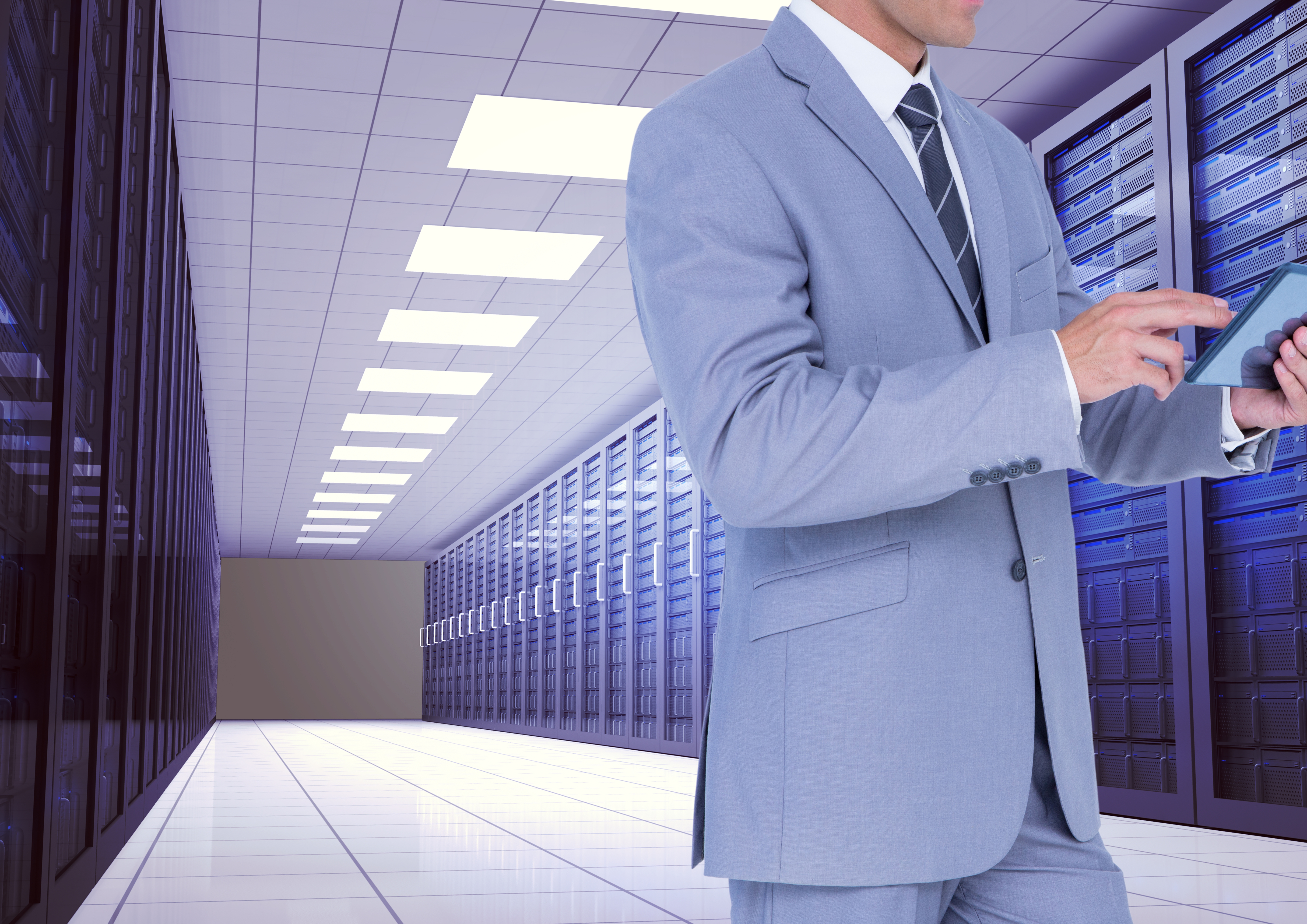 Digital composition of businessman using digital tablet against server room background